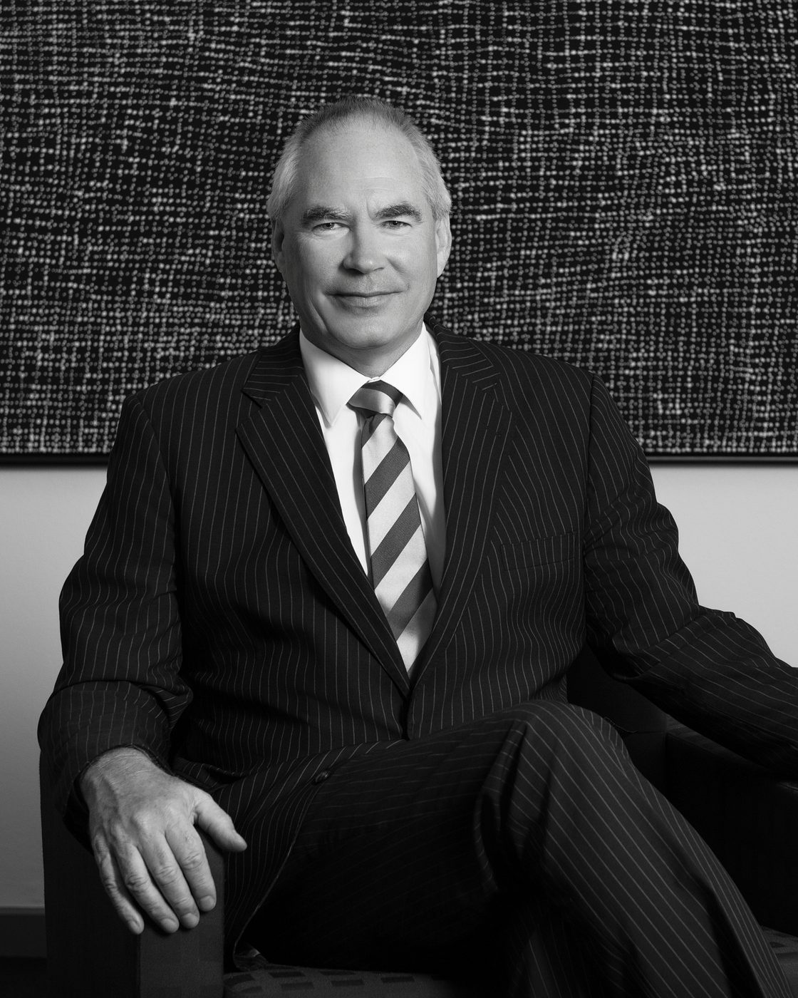 Black and white portrait of a seated executive